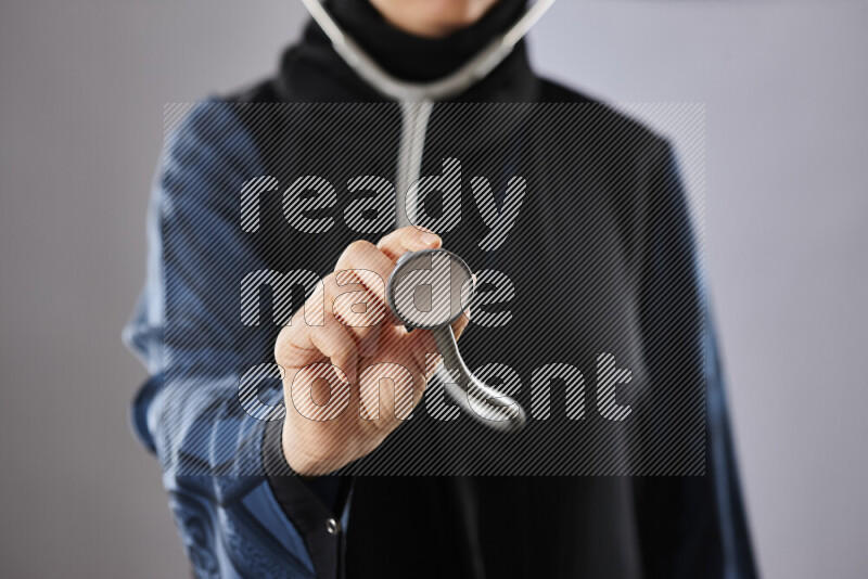 Female doctor wearing an abaya and medical attire in different positions