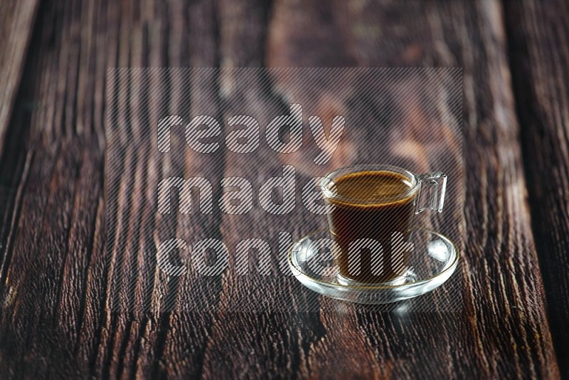 A coffee glass cup with dates and tea on wooden background