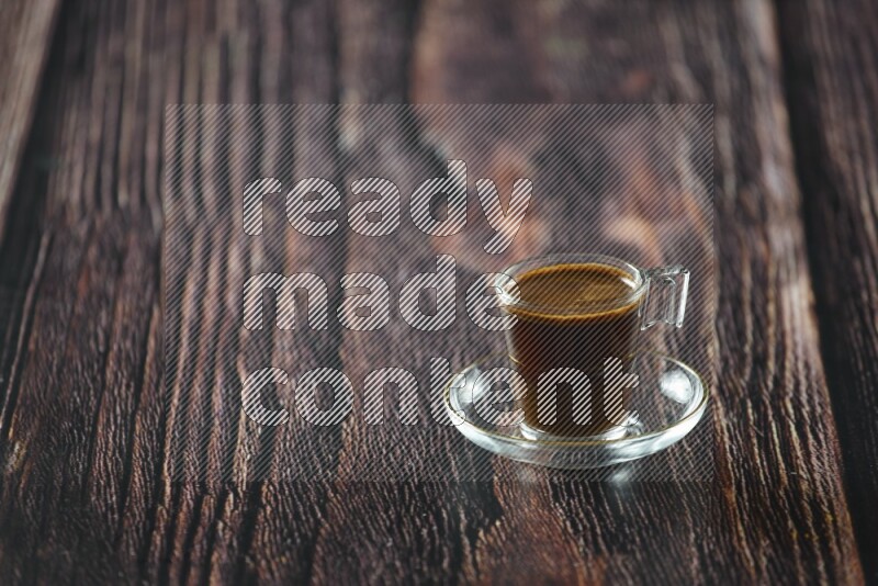 A coffee glass cup with dates and tea on wooden background