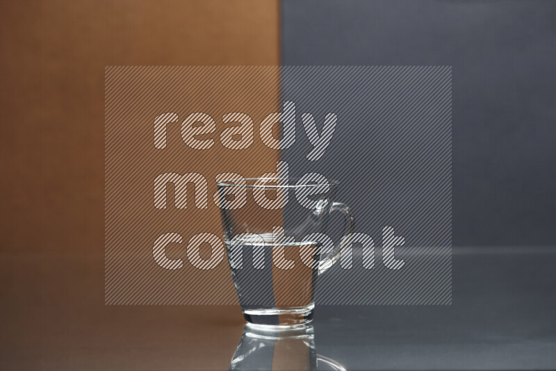 The image features a clear glassware filled with water, set against brown and dark blue background