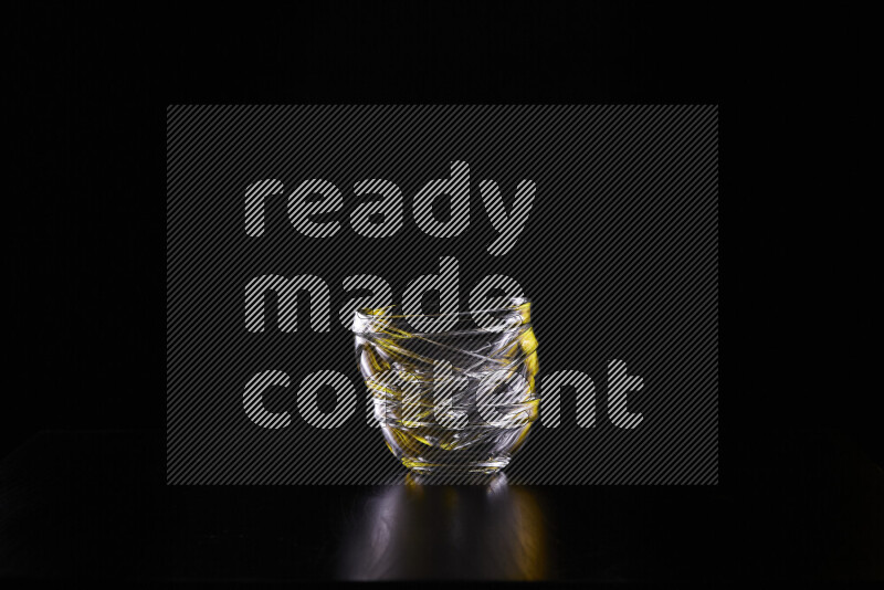 Glassware with rim light in yellow and white against black background