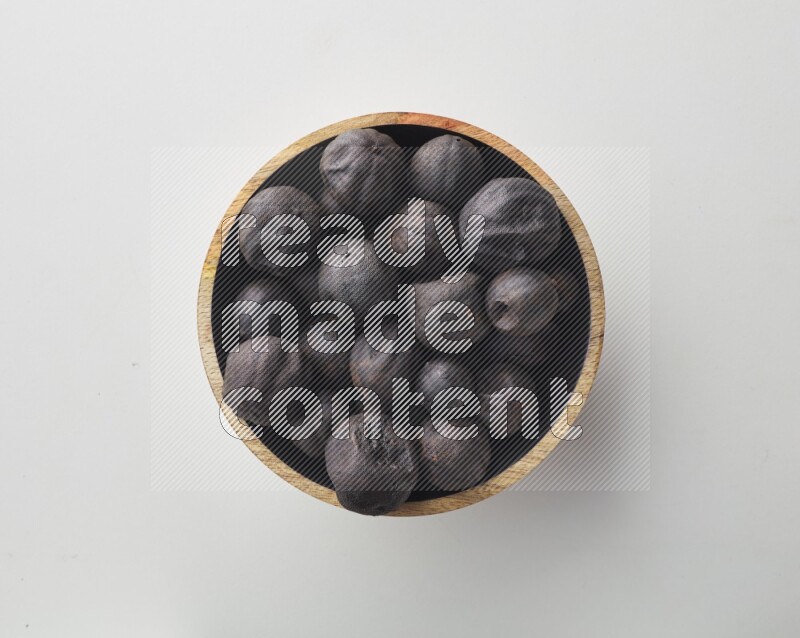 Top-view shot of dried lime (loomi) in a container on white background