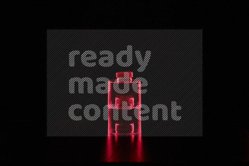 Glassware with rim light in red against black background