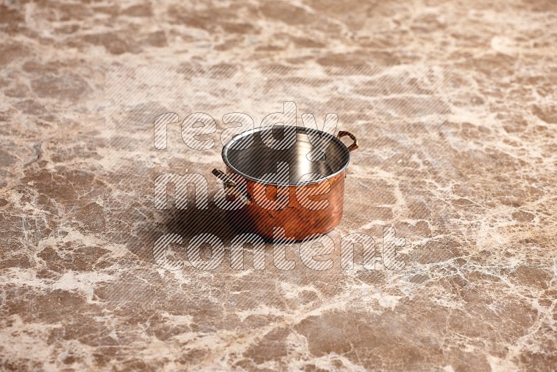 Small Copper Pot on Beige Marble Flooring, 45 degrees