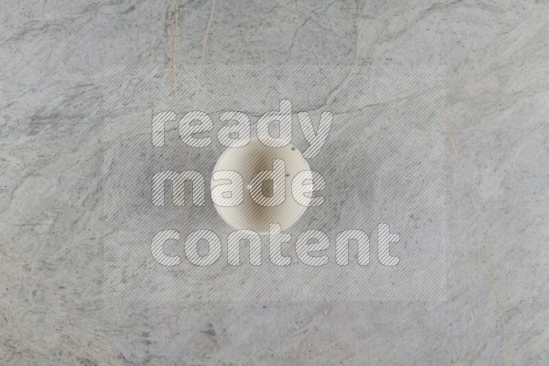 A white pottery bowl on grey marble background