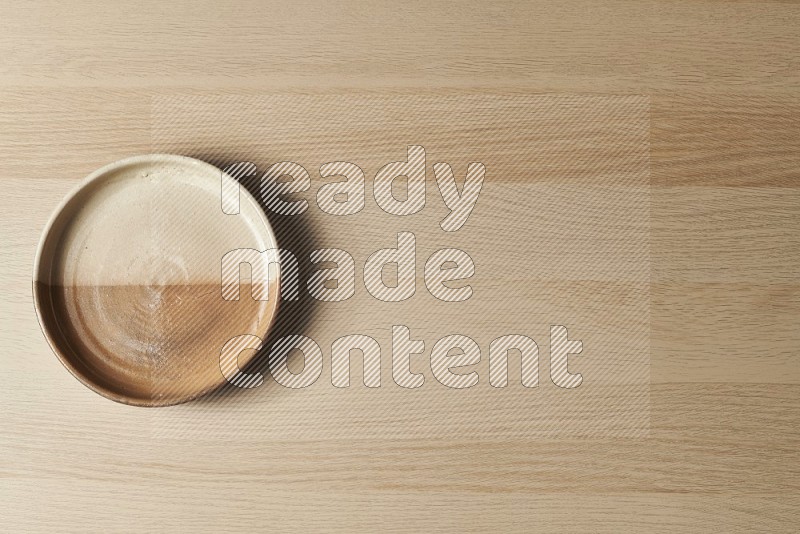 Top View Shot Of A Multicolored Pottery Oven Plate on Oak Wooden Flooring