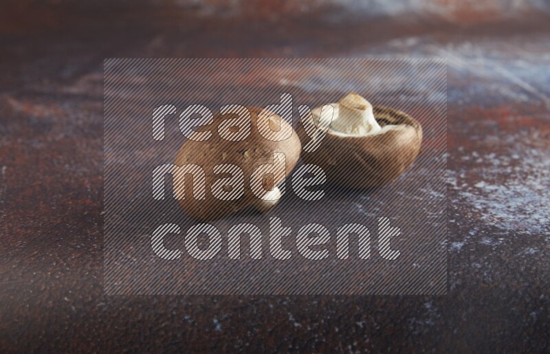 45 degre cremini  mushrooms on a textured reddish rustic metal background