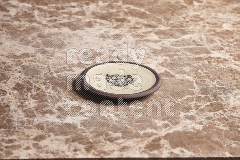 Decorative Pottery Plate on Beige Marble Flooring