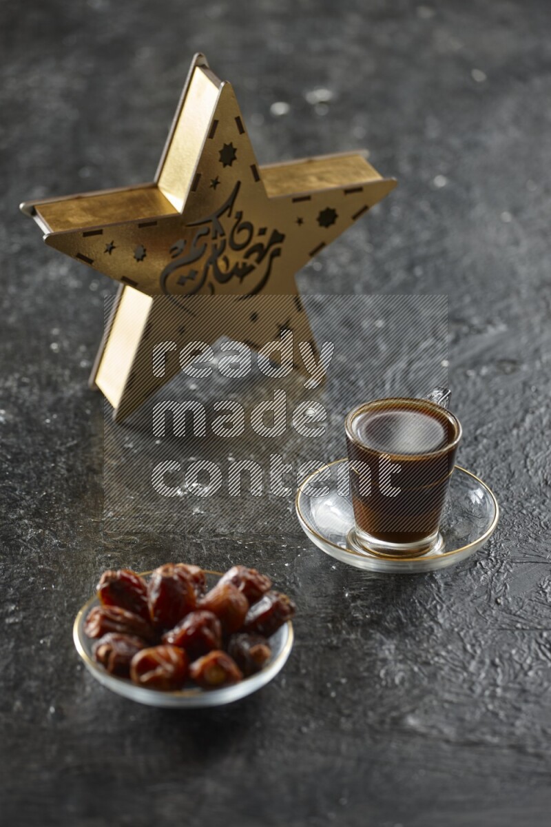 A wooden golden star lantern with different drinks, dates, nuts, prayer beads and quran on textured black background
