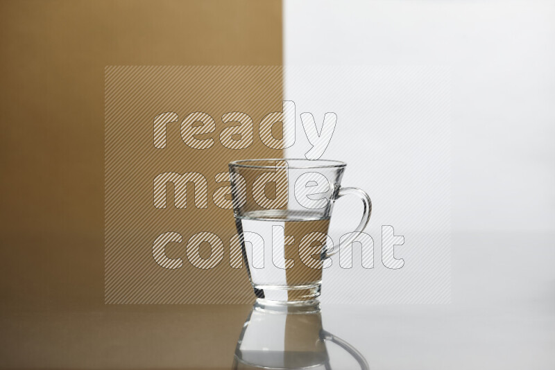 The image features a clear glassware filled with water, set against white and beige background