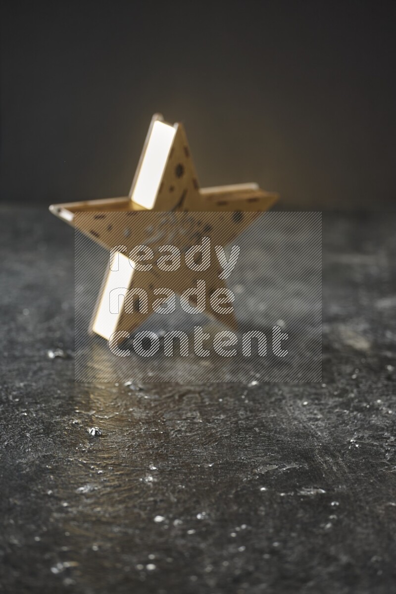 An out of focus lantern on textured black background