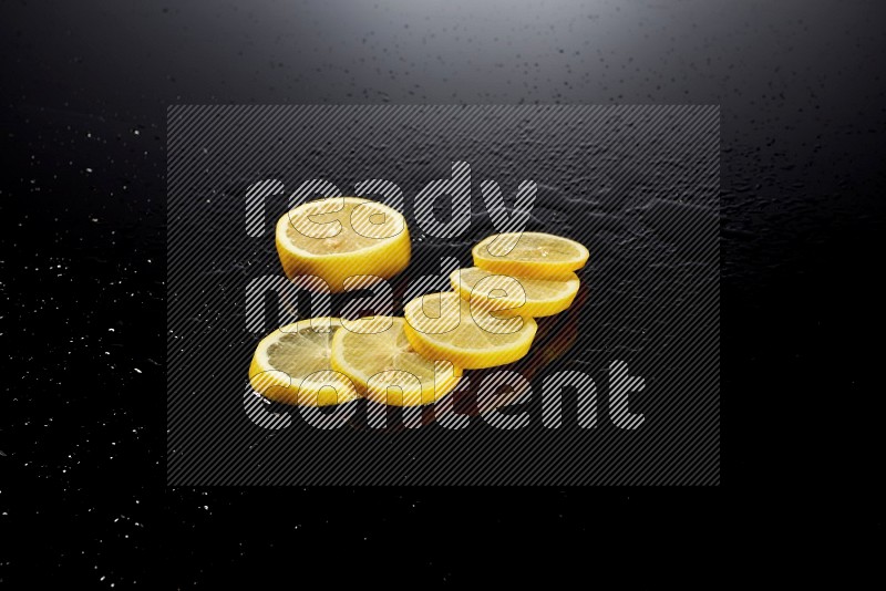 Lemon slices with water drops, and droplets on black background