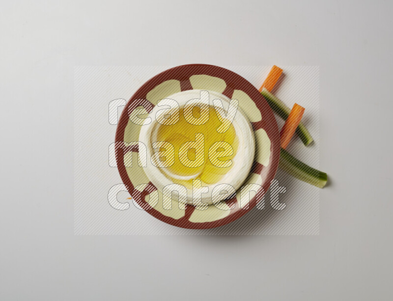 Lebnah garnished with olive oil in a traditional plate on a white background