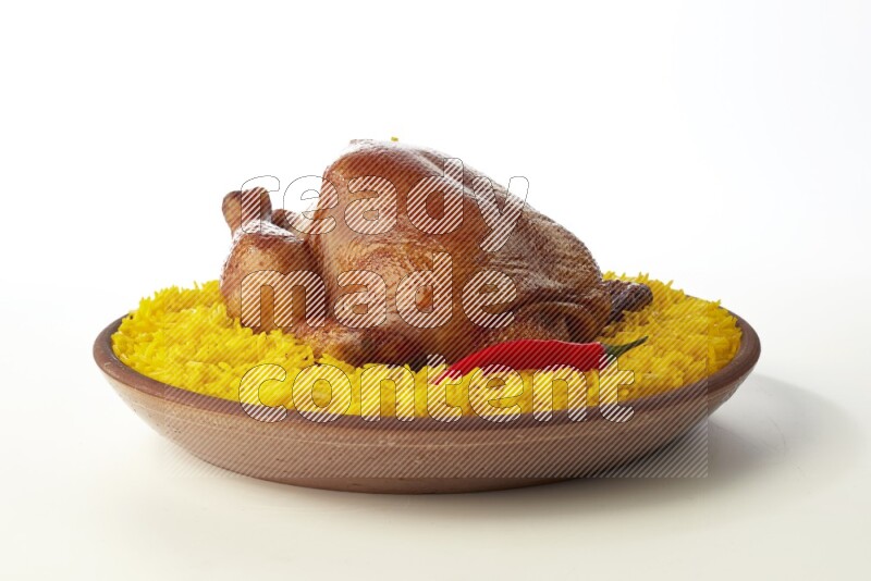 yellow basmati Rice with whole roasted chicken  on a pottery plate  direct  on white background