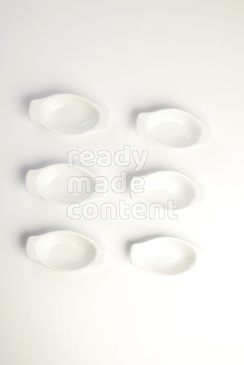 white ceramic oval sauce dish on white countertop