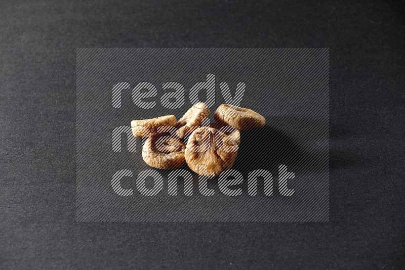 Dried figs on a black background in different angles