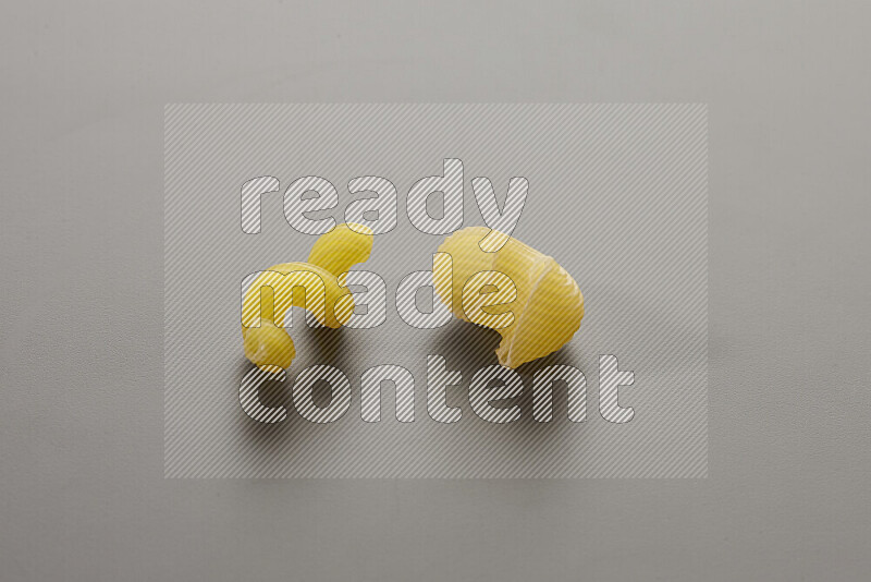 Twist pasta with other types of pasta on grey background