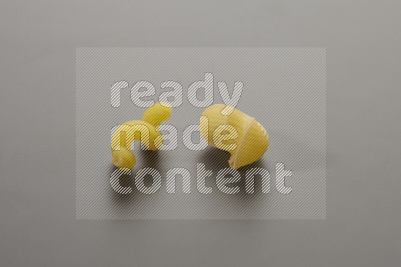 Twist pasta with other types of pasta on grey background