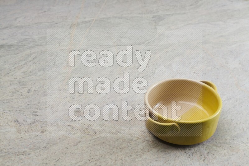 A multicolored pottery bowl on grey marble background