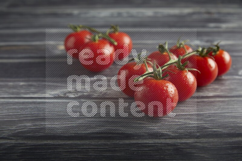 Red cherry tomato vein on a textured grey wooden background 45 degree