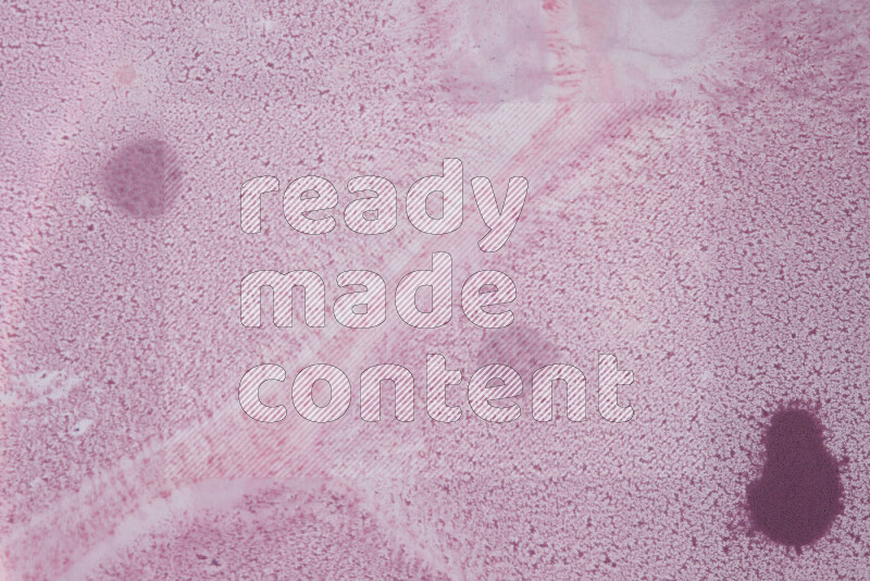 The image captures a dramatic splatter of purple paint over a white backdrop