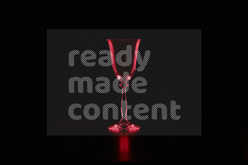 Glassware with rim light in red against black background