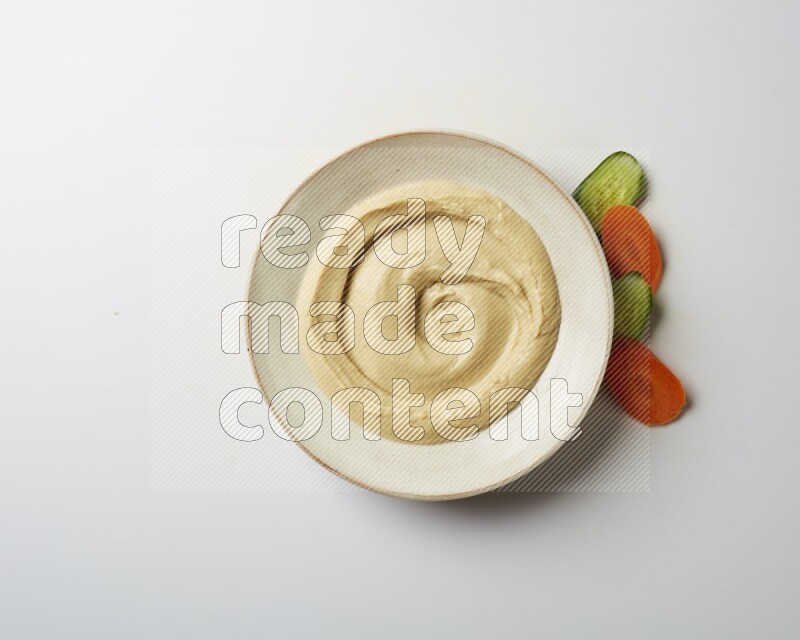 plain Hummus in a pottry plate  on a white background