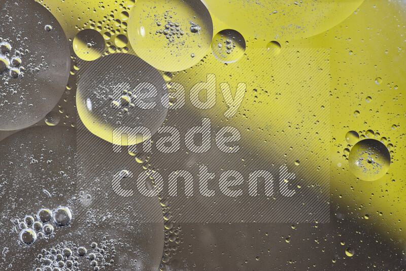 Close-ups of abstract oil bubbles on water surface in shades of yellow and brown