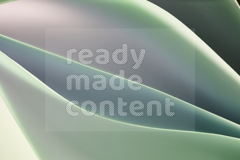 This image showcases an abstract paper art composition with paper curves in green and white gradients created by colored light