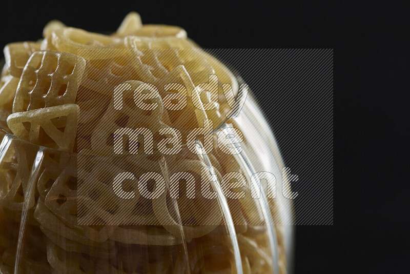 Snacks in a glass jar on black background