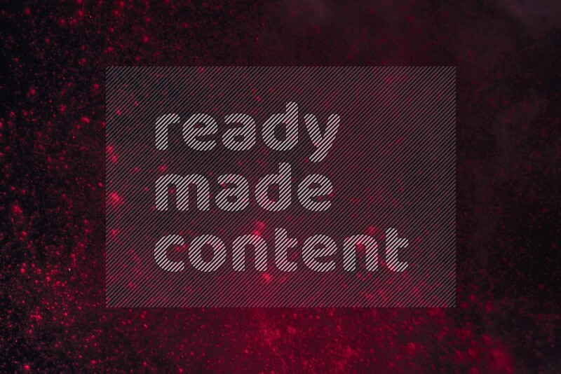Red powder explosion on black background