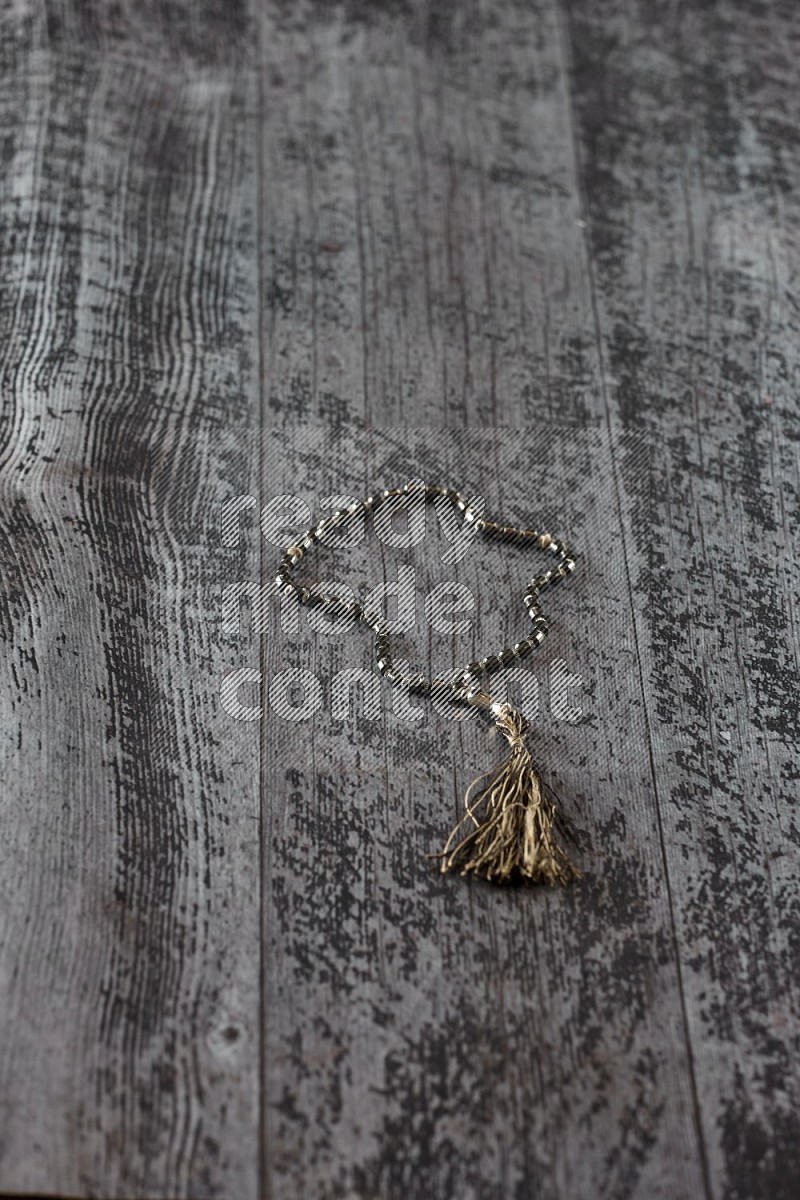 Prayer beads on wooden background