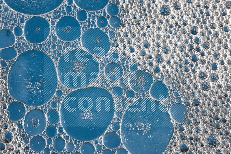 Close-ups of abstract soap bubbles and water droplets on blue background