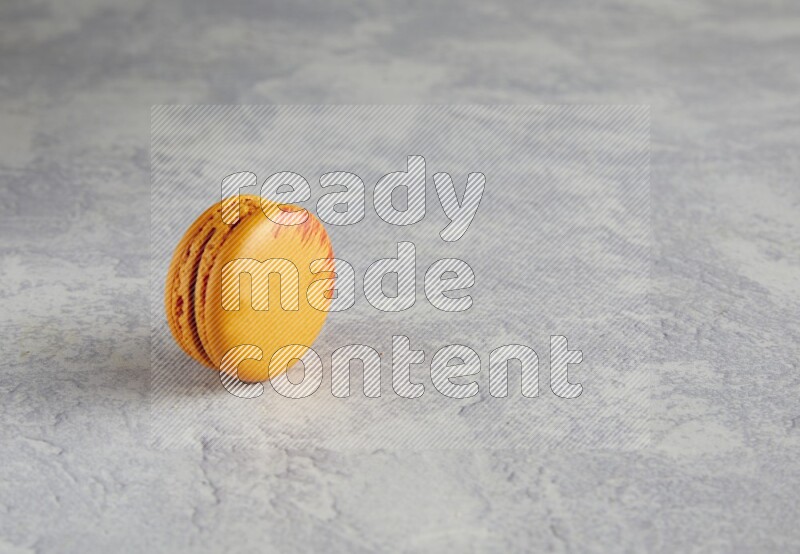 45º Shot of Orange Exotic macaron on white  marble background
