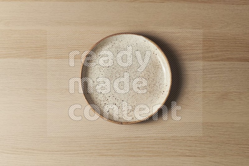 Top View Shot Of A Multicolored Pottery Plate on Oak Wooden Flooring