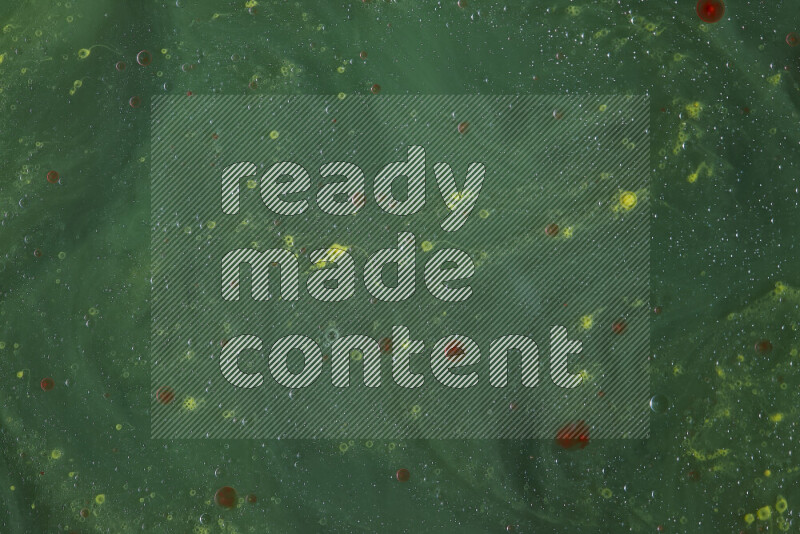 The image captures a dramatic splatter of red, green and yellow paints over the backdrop