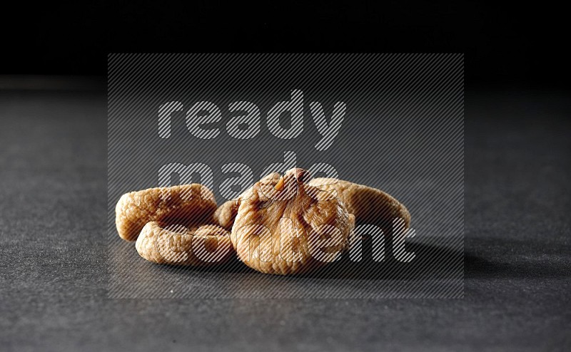 Dried figs on a black background in different angles