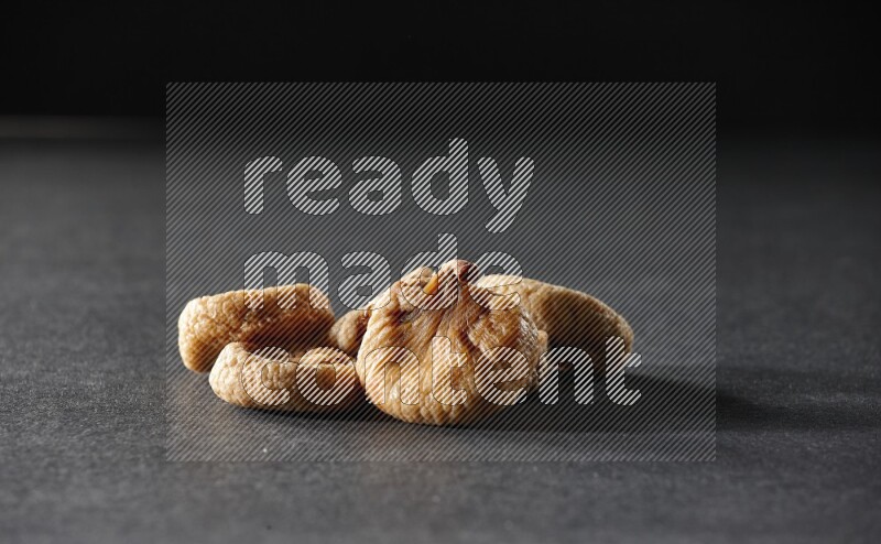 Dried figs on a black background in different angles