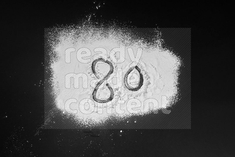 Numbers written with powder on black background