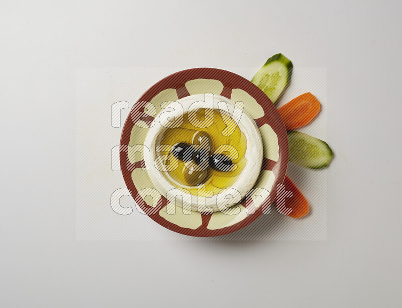 Lebnah garnished with olives in a traditional plate on a white background