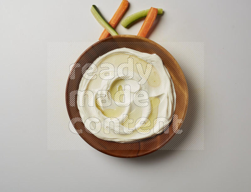 Lebnah garnished with olive oil in a wooden plate on a white background