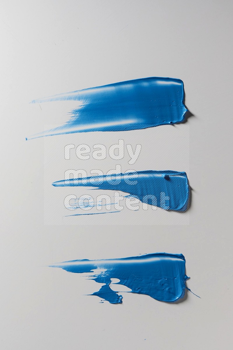 Blue painting knife strokes on a white background