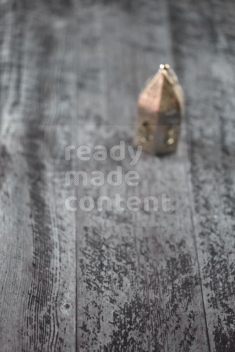 An out of focus lantern on wooden background