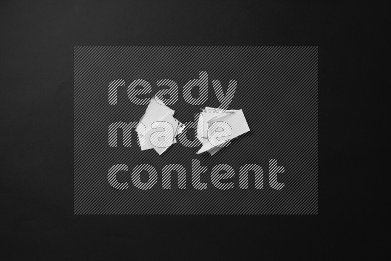 Ripped notebook sheet on black background