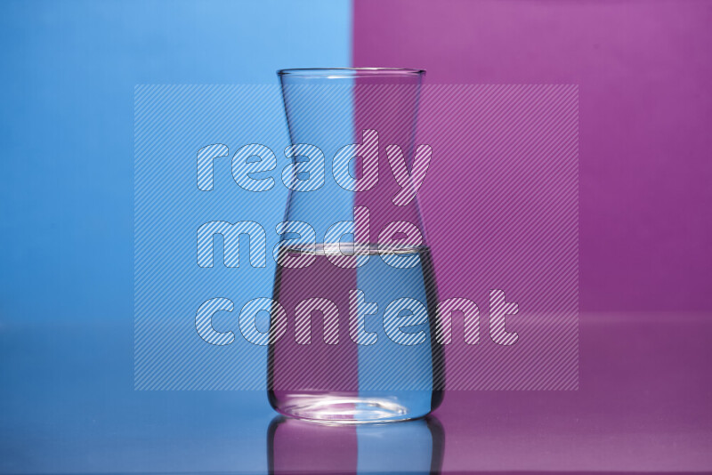 The image features a clear glassware filled with water, set against blue and purple background