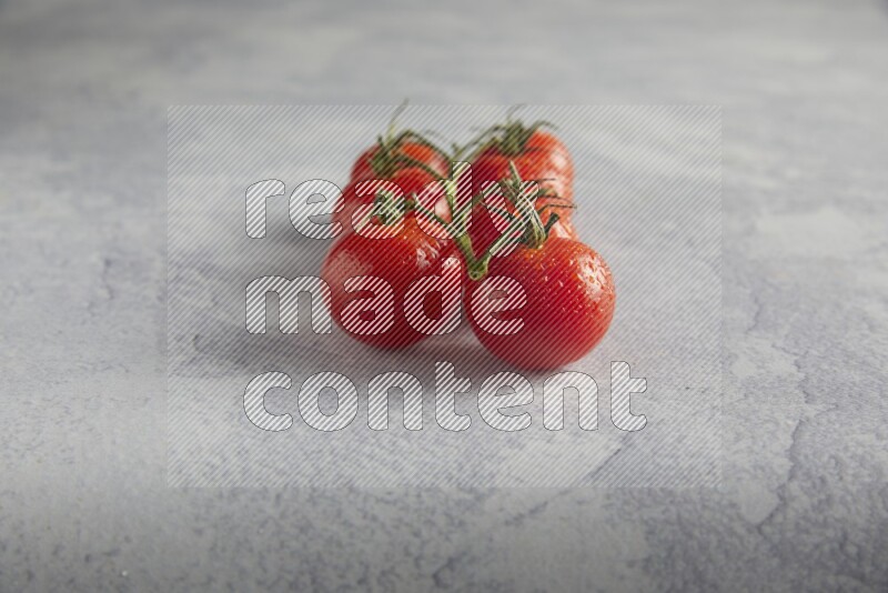 Red cherry tomato vein on a light grey textured background 45 degree