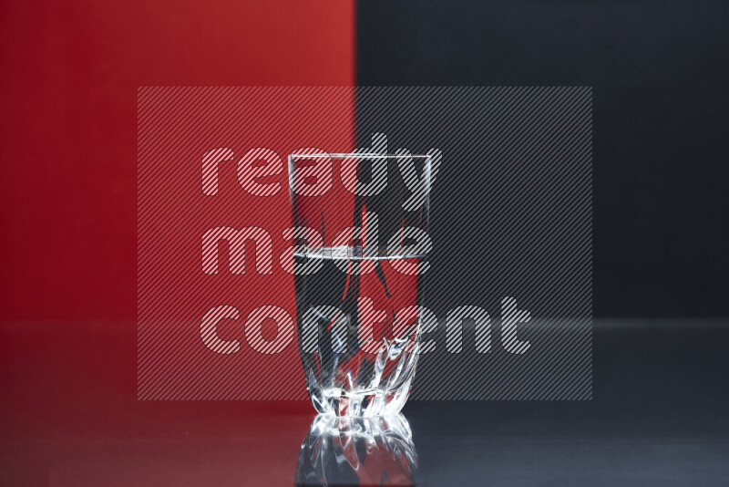 The image features a clear glassware filled with water, set against red and black background