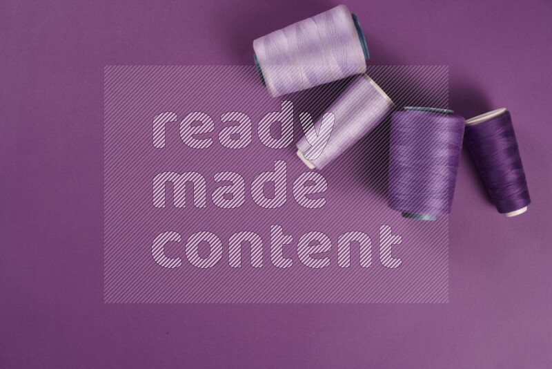 A purple collection of sewing and tailoring tools arranged on a purple background