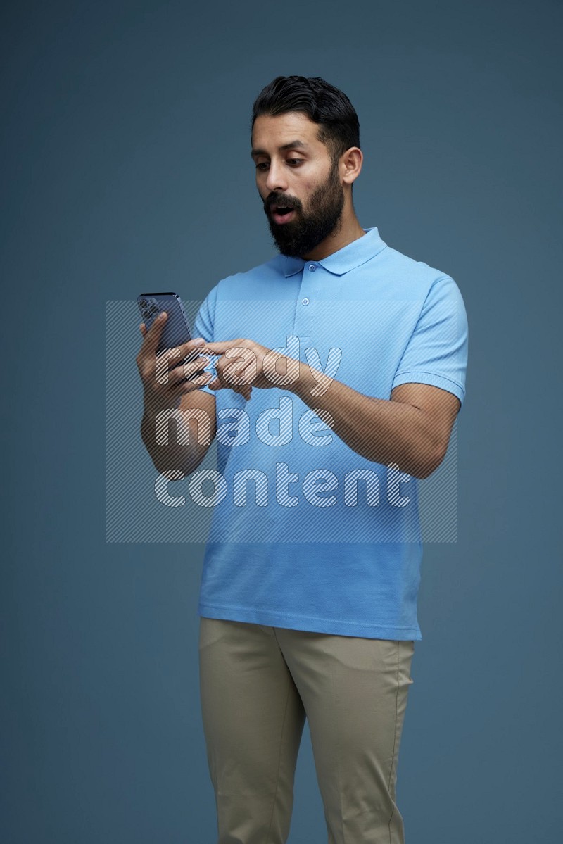 A man Swiping in a blue background wearing a Blue shirt