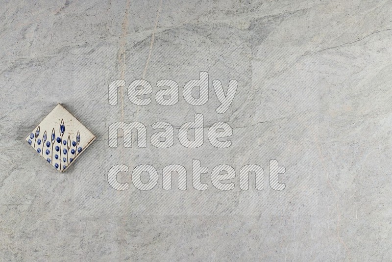Top View Shot Of A Pottery Coaster tile On Grey Marble Flooring